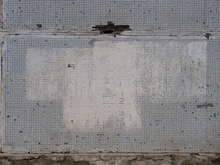 old gray wall with spots of white paint