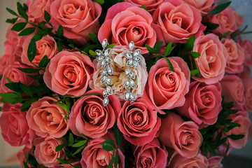 Jewelry lies on a bouquet of roses