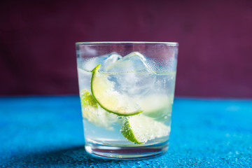 Rum based cocktail caipirinha (variation of cuba libre) on the rustic background. Selective focus. Shallow depth of field.
