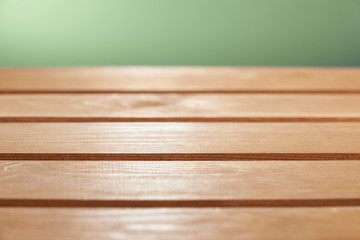Wooden floor board on green background. The background is blurred.