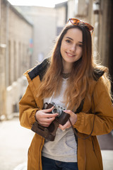 Photo of young tourist girl exploring streets of Baku. Moody photos of teenager girl visiting old city and taking photos of the city