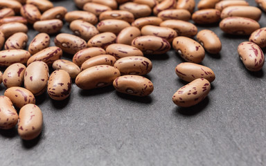 close up of cranberry beans with black background