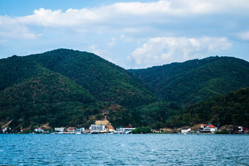 Fototapeta premium The Romanian shore seen from a boat, Danube river. Dubova golf, Cazanele Dunarii. Romania. 