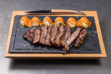 Beef cut into entrecote steak with potato