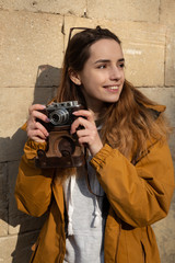 Photo of young tourist girl exploring streets of Baku. Moody photos of teenager girl visiting old city and taking photos of the city