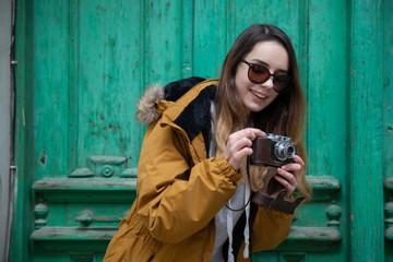 Photo of young tourist girl exploring streets of Baku. Moody photos of teenager girl visiting old city and taking photos of the city