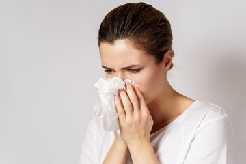 Young woman with a runny nose symptom