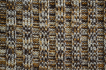 Knitted texture pattern melange in dark brown tones. Background template for the design of the banner, site, card, wallpaper, textile canvas. Fashionable concept.
