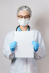 Fototapeta premium Doctor is holding paper is holding a sheet of blank white paper