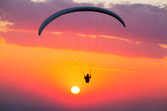 paragliding flying alone at beautiful sunset, Brazil