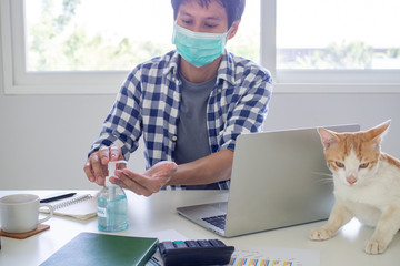 Business people work from home wear masks and use alcohol sanitizer to prevent the spread of the covid-19 virus. work from home and stay safe concept