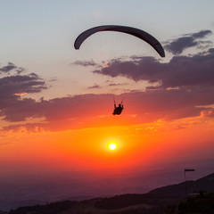 paragliding flying at beautiful sunset