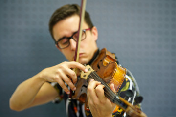 Musician playing violin with Pizzicato technique, close up
