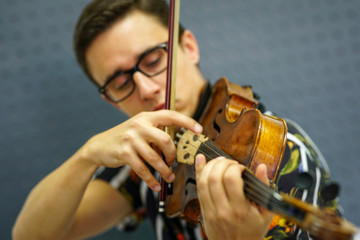 Musician playing violin with Pizzicato technique, close up