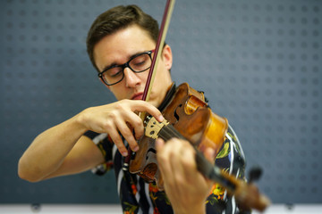 Musician playing violin with Pizzicato technique, close up