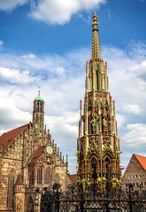 Fototapeta na wymiar Nurnberg, Germany: Schöner Brunnen (en.beautiful fountain) is a 14th-century (built from 1385 to 1396) fountain located on Nuremberg main market next to the town hall.