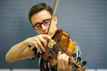 Musician playing violin with Pizzicato technique, close up