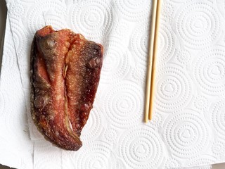 Pieces of catfish fried absorb oil on tissue paper