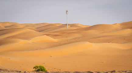 a mobile tower standing in between sand dunes at Liwa desert, Liwa desert, Moreeb dunes Liwa, Liwa motor festival, empty quarter