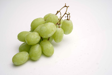 Fresh green seedless grapes on white. stock photo