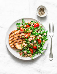 Vegetarian white beans, arugula, cherry tomatoes salad - delicious brunch, snack on a light background, top view
