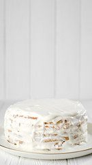 biscuits cake with white cream. 
a lot of cream on the cake. white background. closeup