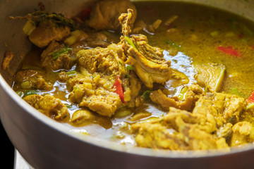 curried chicken and red bell peppers in a stew