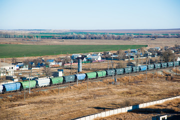 Obraz premium Freight train crossing through railroad station