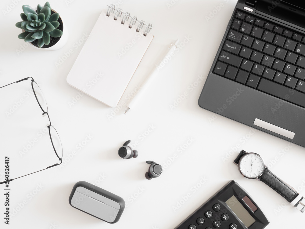 Poster top view of work from home concept with keyboard, calculator and notebook on white background, graph