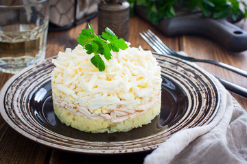 Puff salad with potatoes and cheese, selective focus