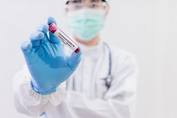 Fototapeta premium Coronavirus (COVID-19) testng concept, The doctor holds a test tube containing a blood sample..