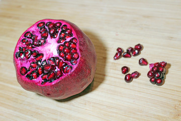 Juicy pomegranate on a wooden texture