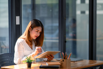 Women stay home use tablet work at home.