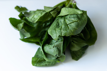 Obraz premium Bunch of green spinach on white background
