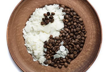 Close up of white soy wax flakes and coffee on brown plate for candle making. Light texture of soy wax flakes. Isolated. Ecological lifestyle