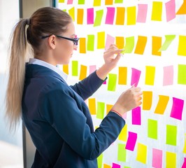 Beautiful female employee with many conflicting priorities