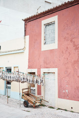 Fototapeta na wymiar Dry fish and old house in the village of island