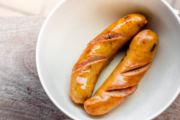 background of the delicious sausages, which are fried or grilled and put on a plate for sale to customers