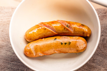 background of the delicious sausages, which are fried or grilled and put on a plate for sale to customers