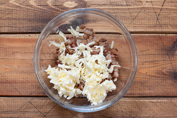 Step-by-step preparation of salted herring paste, step 3 - adding grated frozen butter, top view, horizontal