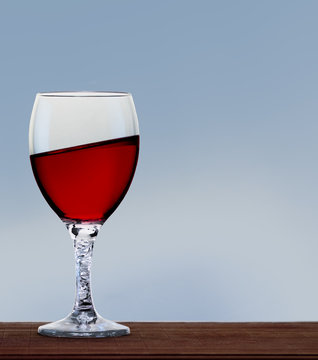 Glass Of Red Wine On Neutral Background. A Tilt Has Been Added For More Dynamic.