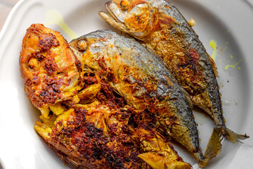 background of the fried fish menu (mackerel)that is fried in fish sauce until the skin is scorched,eaten with steamed rice,an alternative health menu that people like to order in restaurants