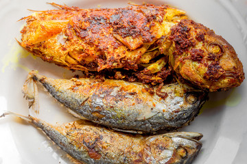 background of the fried fish menu (mackerel)that is fried in fish sauce until the skin is scorched,eaten with steamed rice,an alternative health menu that people like to order in restaurants