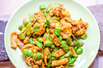 blurred background view of the spicy southern Thai food(stir-fried spicy Sato with fresh prawns),which has a mixture of colorful spices catching the customers, a popular menu eaten with steamed rice