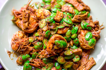 blurred background view of the spicy southern Thai food(stir-fried spicy Sato with fresh prawns),which has a mixture of colorful spices catching the customers, a popular menu eaten with steamed rice