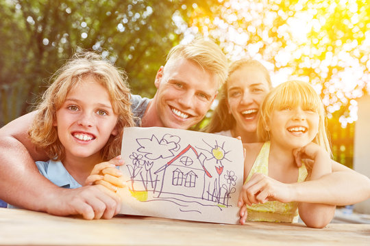 Children and family with drawing of their dream house