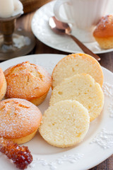 Homemade vanilla muffins sprinkled with icing sugar, selective focus