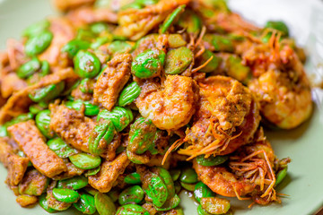 blurred background view of the spicy southern Thai food(stir-fried spicy Sato with fresh prawns),which has a mixture of colorful spices catching the customers, a popular menu eaten with steamed rice