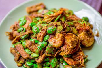 blurred background view of the spicy southern Thai food(stir-fried spicy Sato with fresh prawns),which has a mixture of colorful spices catching the customers, a popular menu eaten with steamed rice
