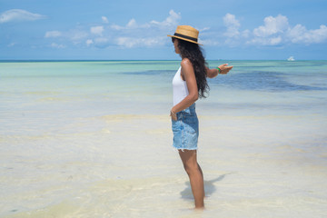 Young indian woman pointing sea